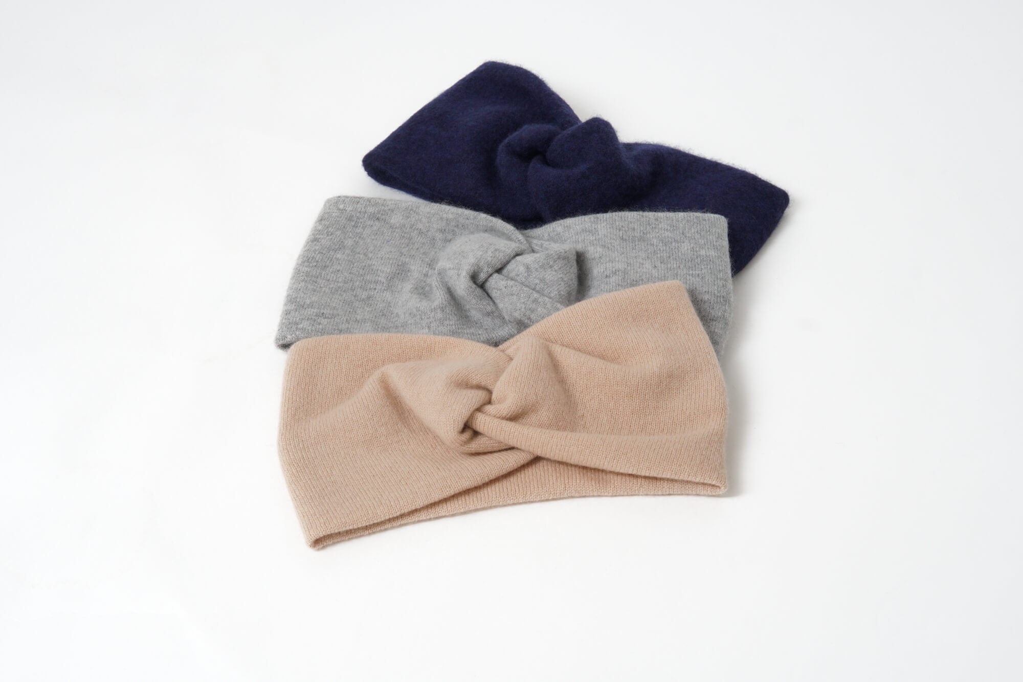 Three headbands in navy, gray, and beige