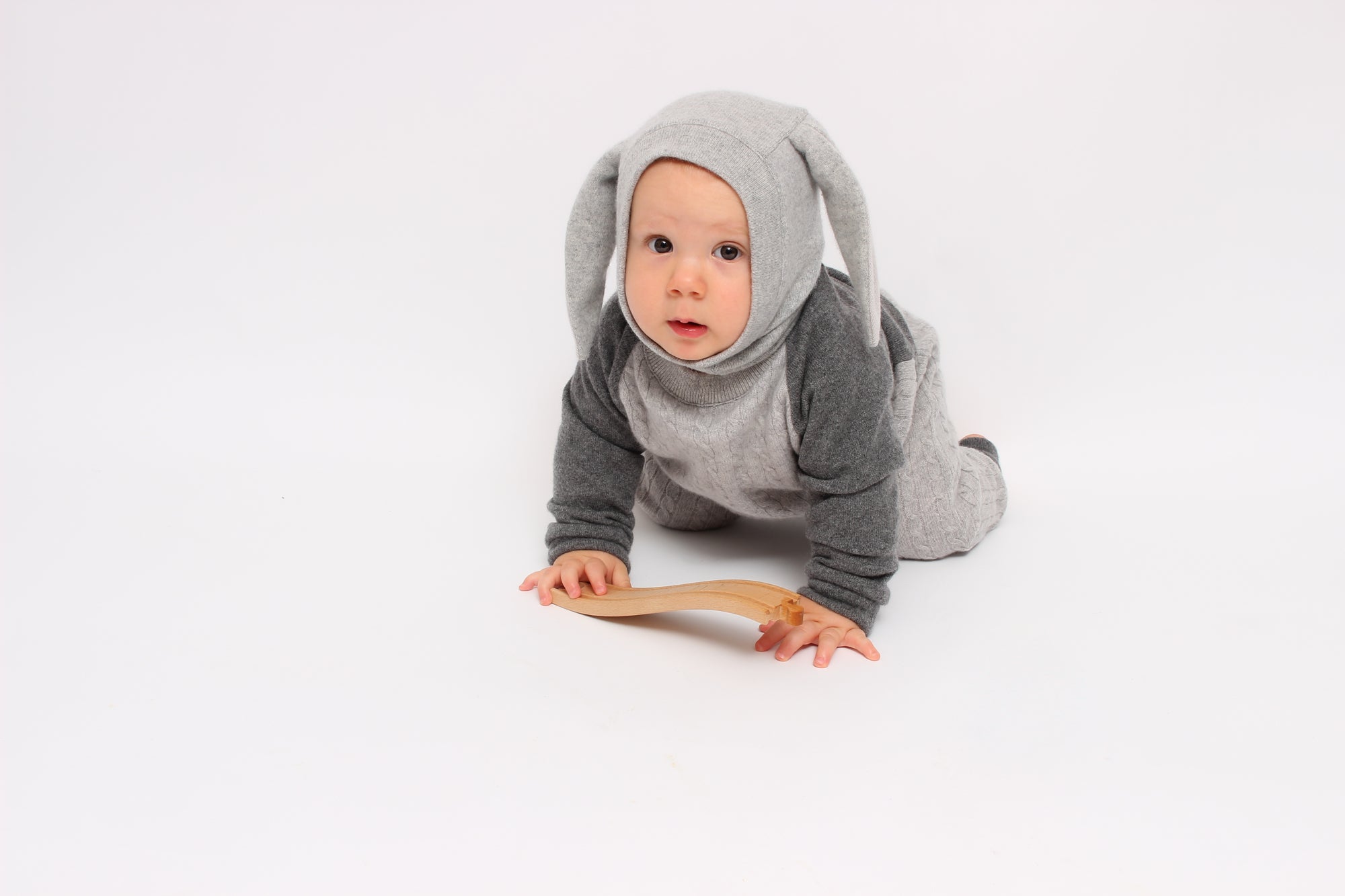 Baby in a gray bunny costume on a white background