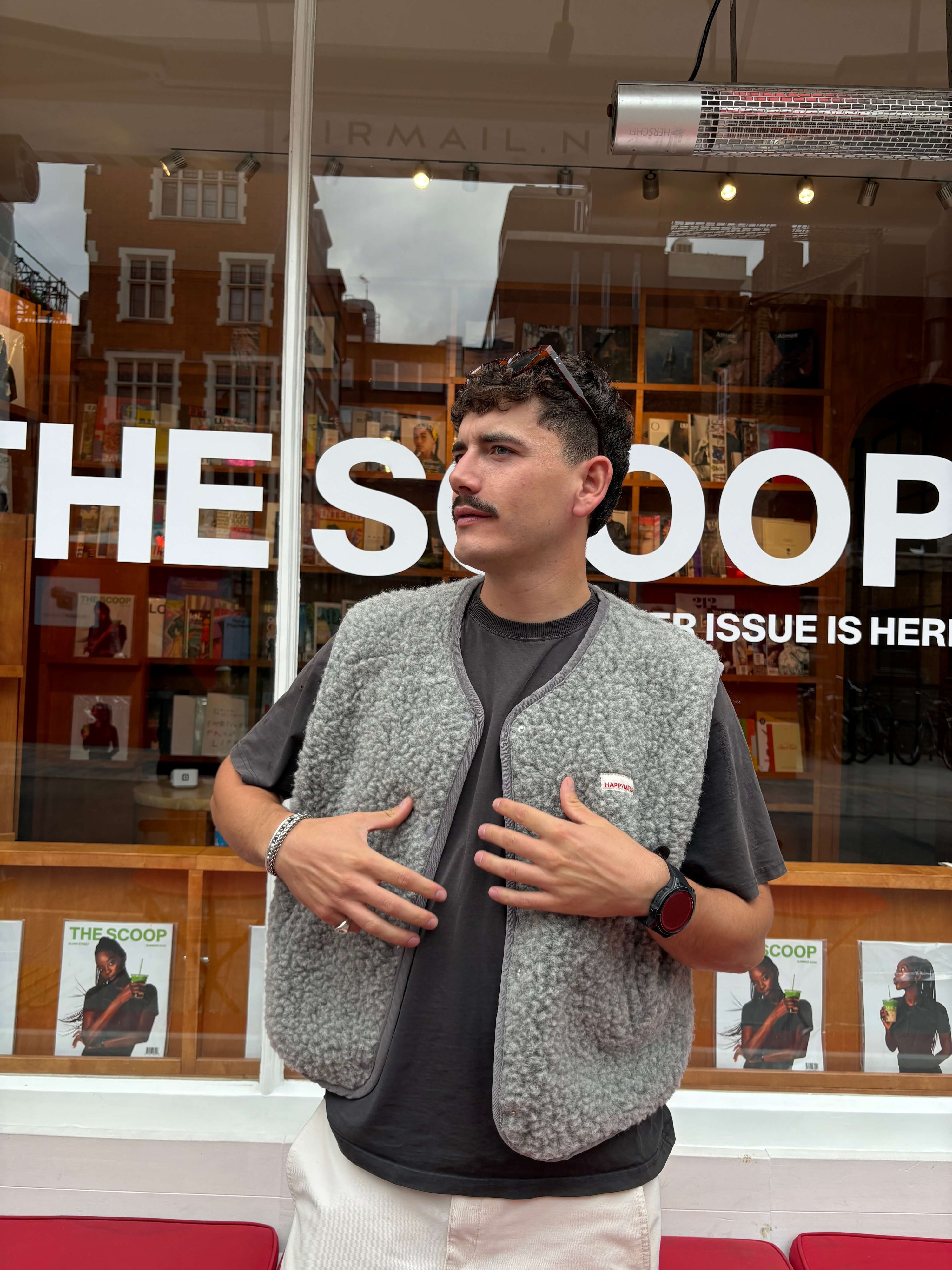 Man standing in front of a store with &