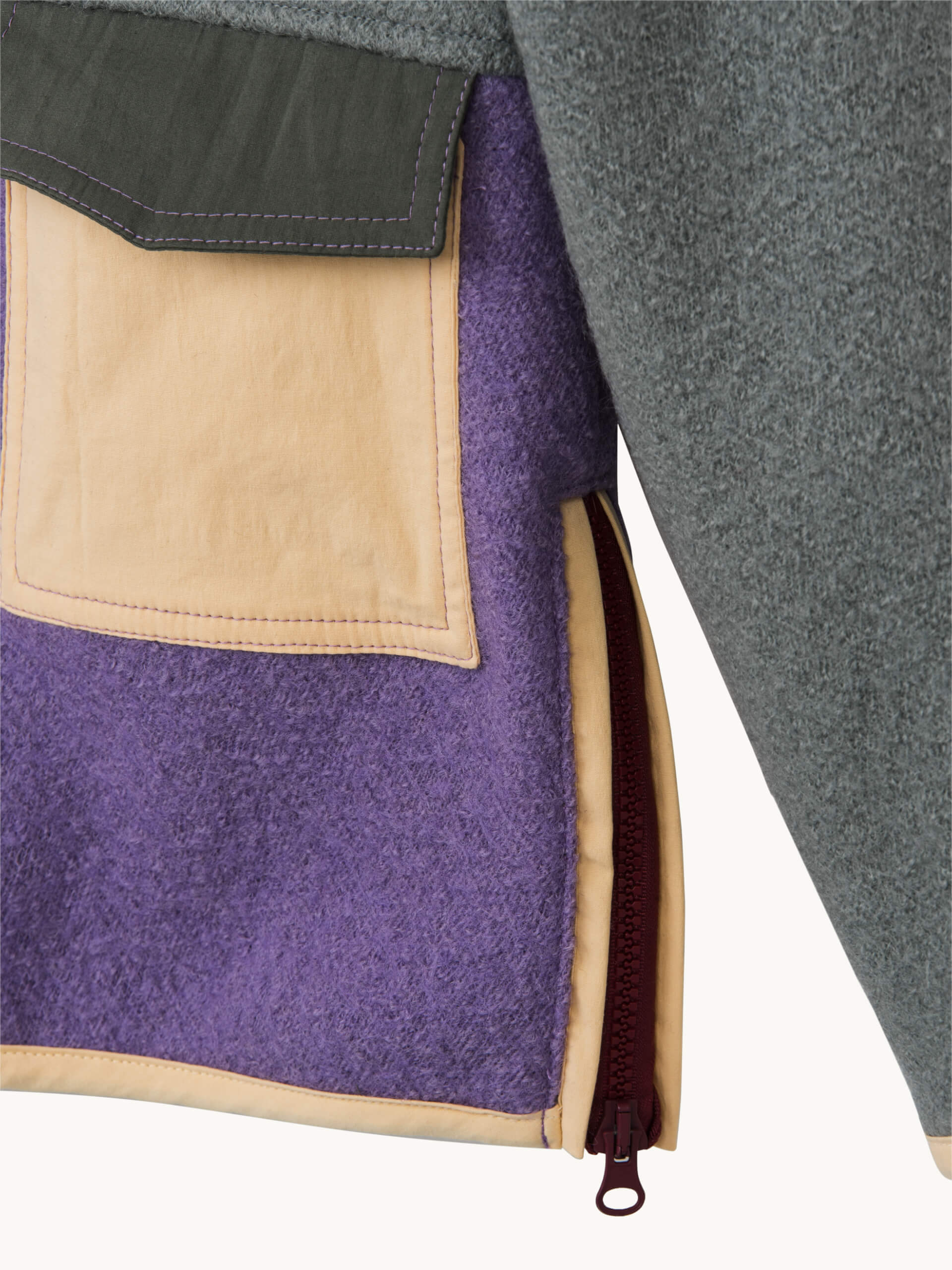 Close-up of a jacket with purple, beige, and gray fabric