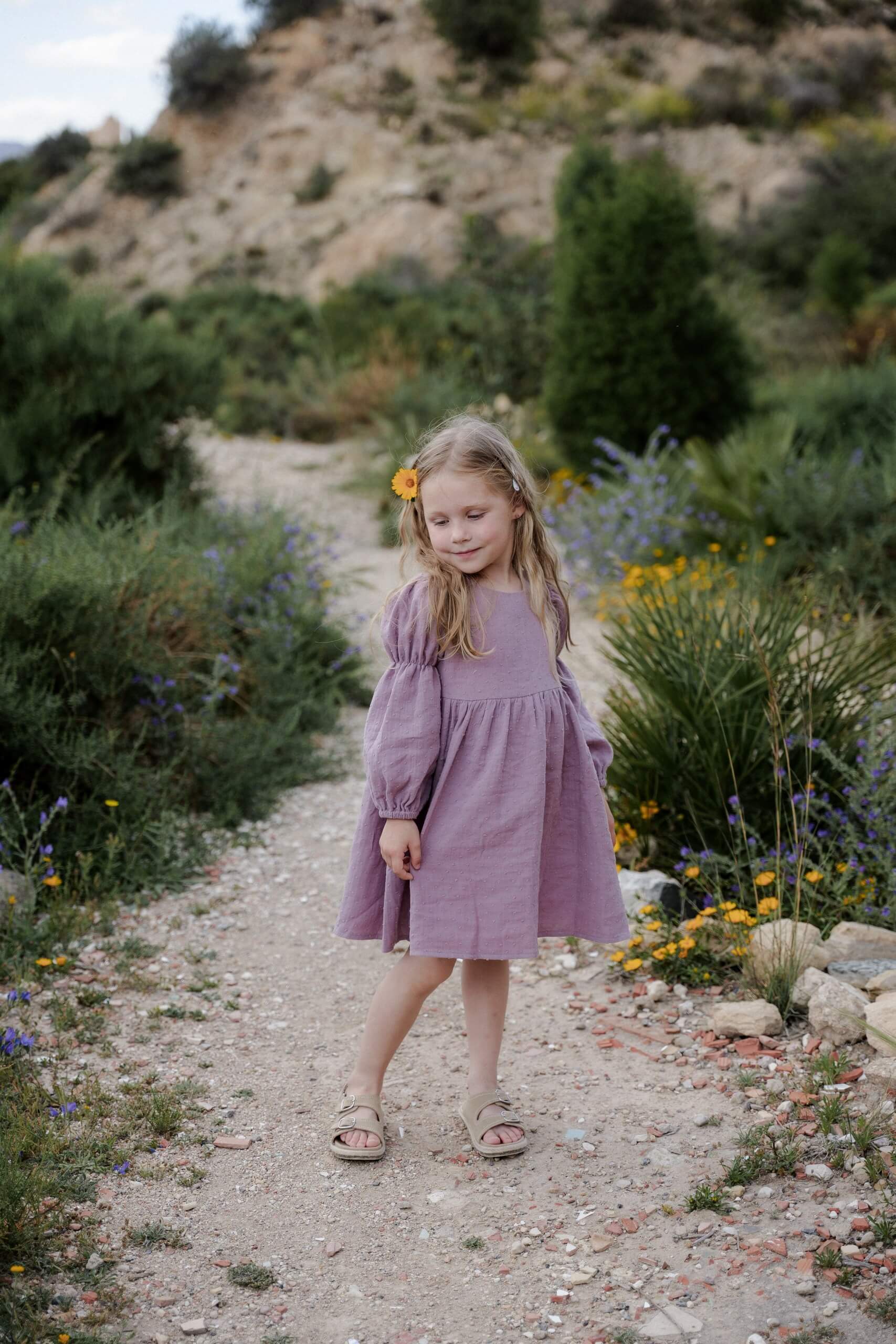 Girl wearing a vintage lavender dress with long sleeves