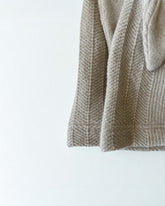 Close-up of a textured beige fabric on a white background