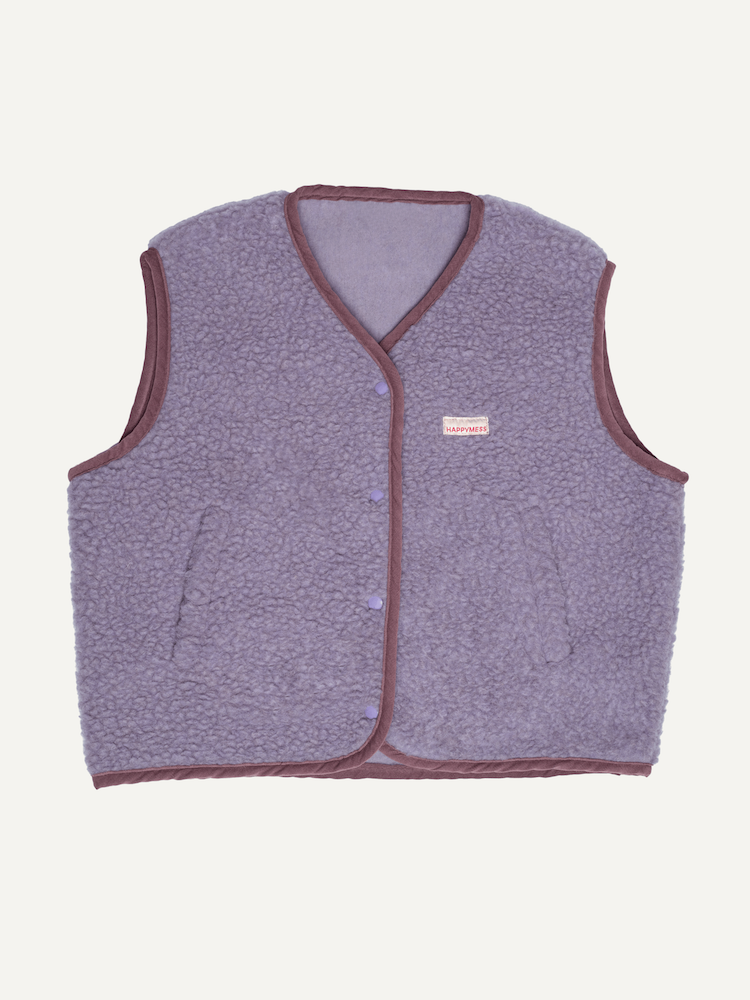 Purple fleece vest with brown trim on a light beige background