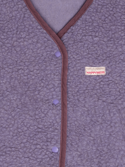 Close-up of a textured fabric with a brand label on a purple background