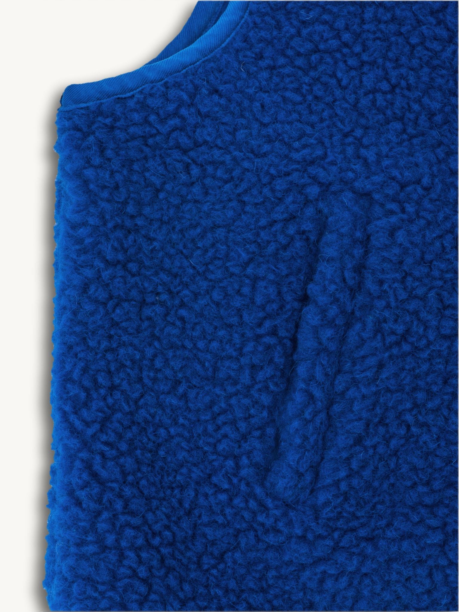 Blue merino wool vest on a white background