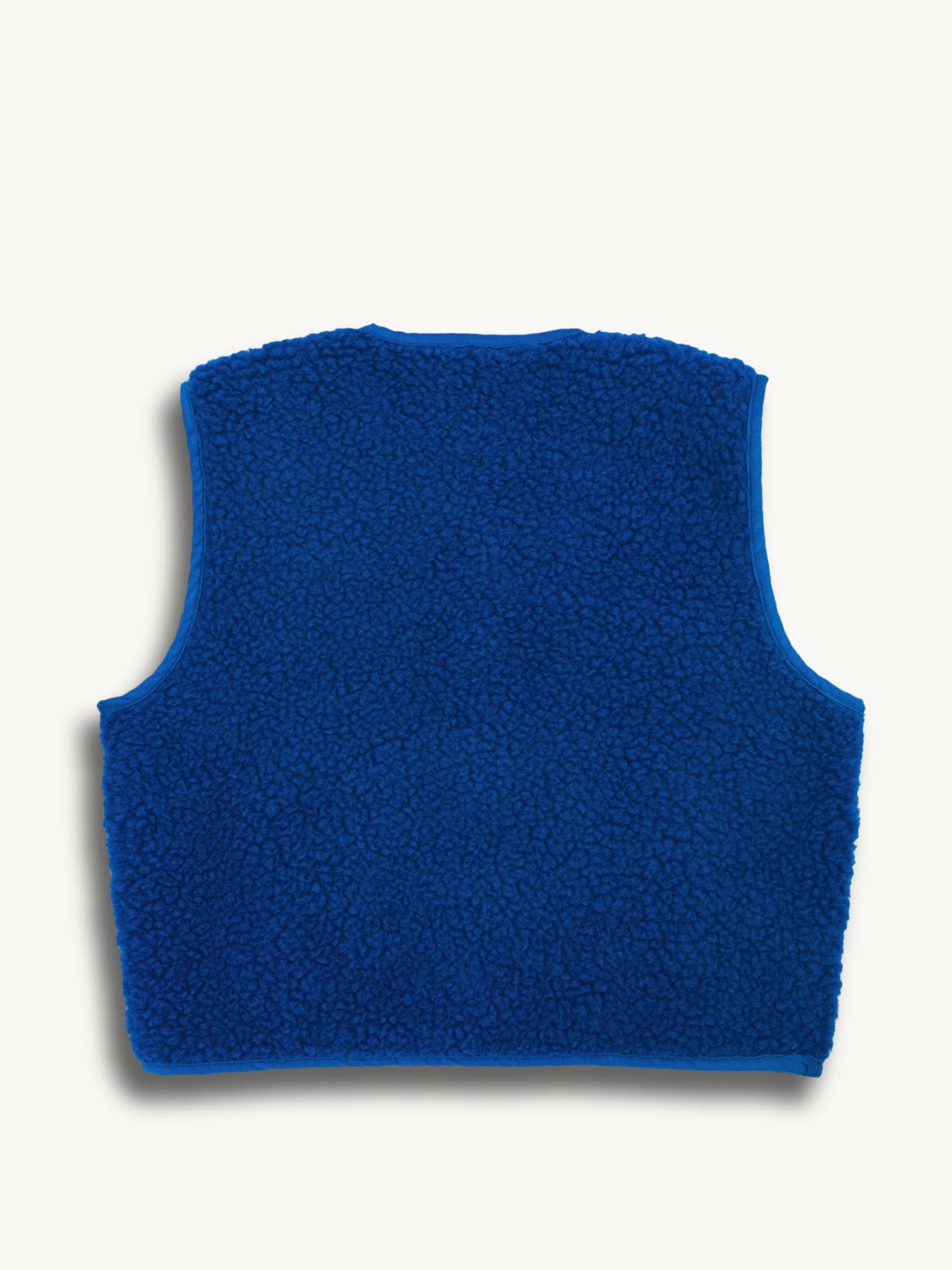 Blue merino wool vest on a white background