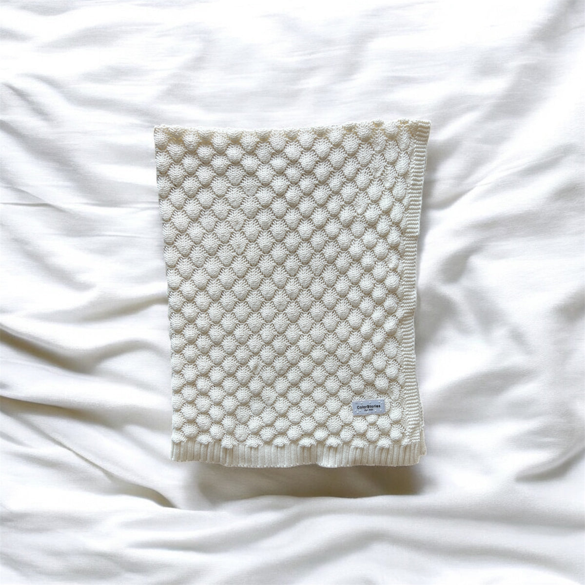 Textured blanket on a white fabric background