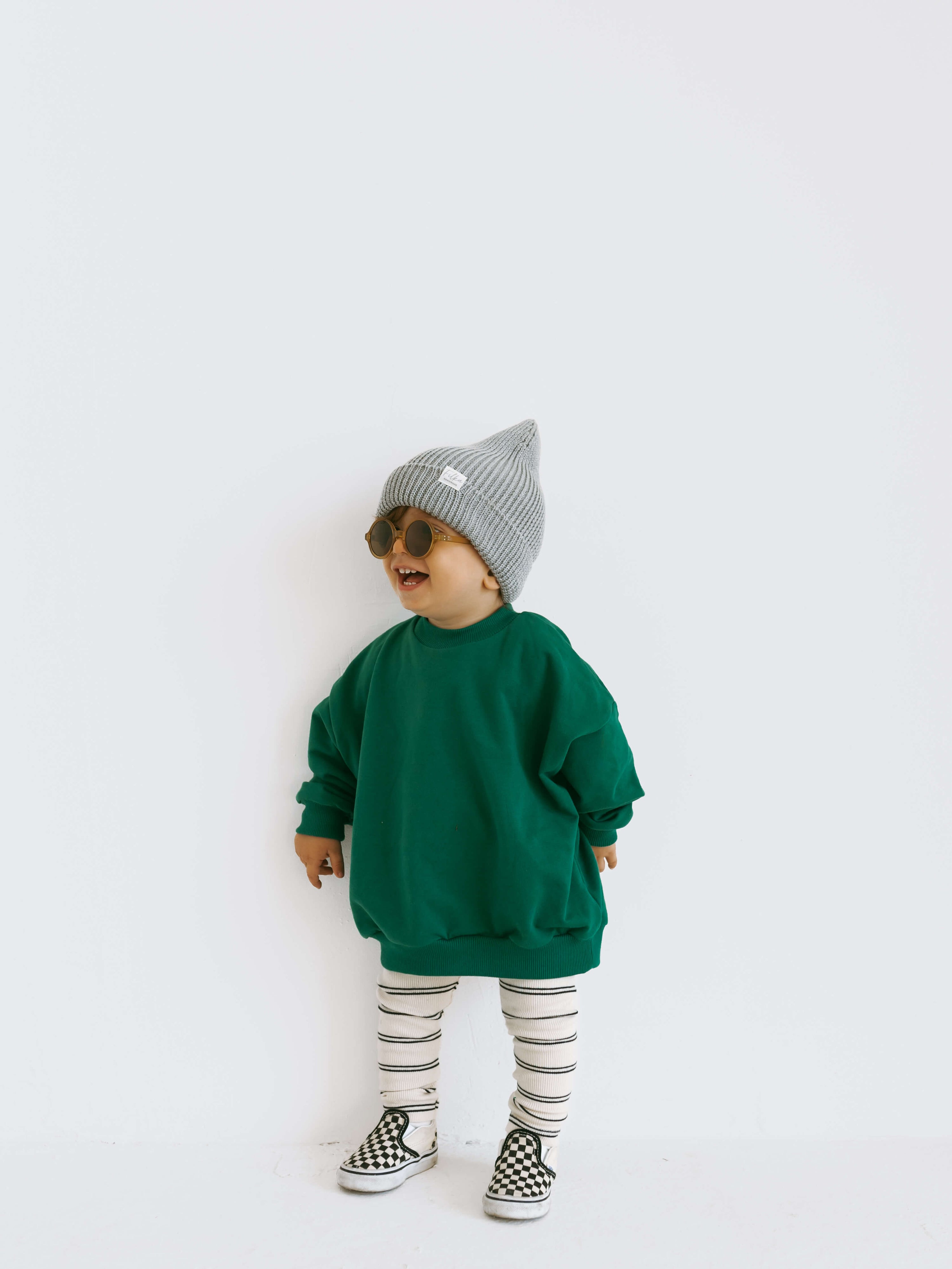 Child wearing green leggings with a striped pattern