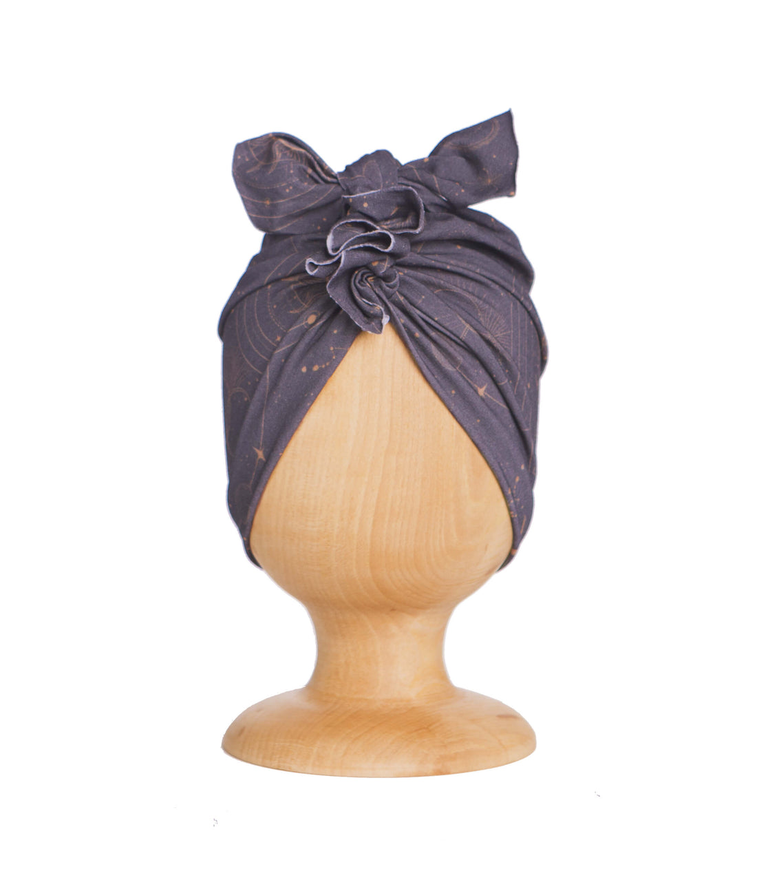 A dark blue turban for children on a wooden mannequin on a white background