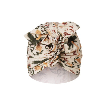 A ecru turban with flower pattern for children on a white background