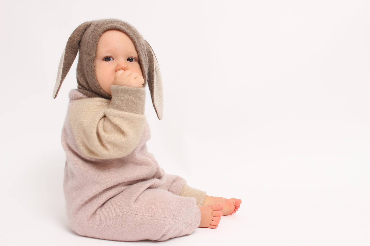 Baby in a bunny costume on a white background