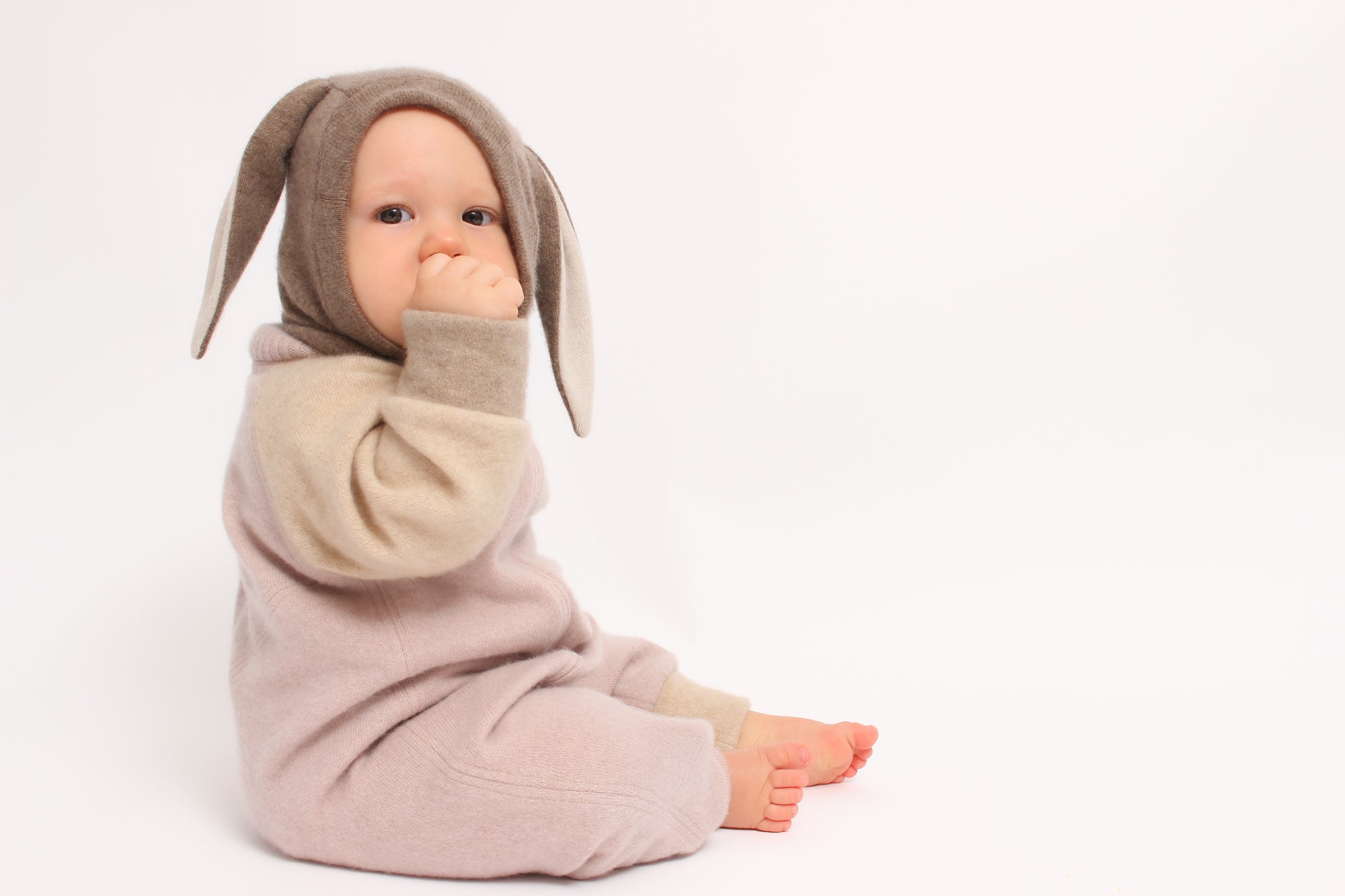 Baby in a bunny costume on a white background