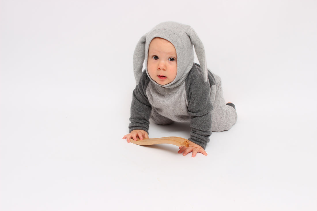 Baby in a gray bunny costume on a white background