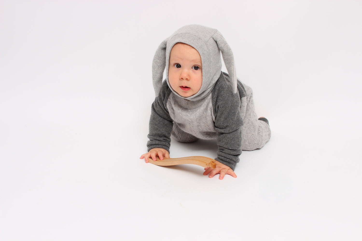 Baby in a gray bunny costume on a white background