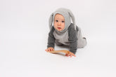 Baby in a gray bunny costume on a white background