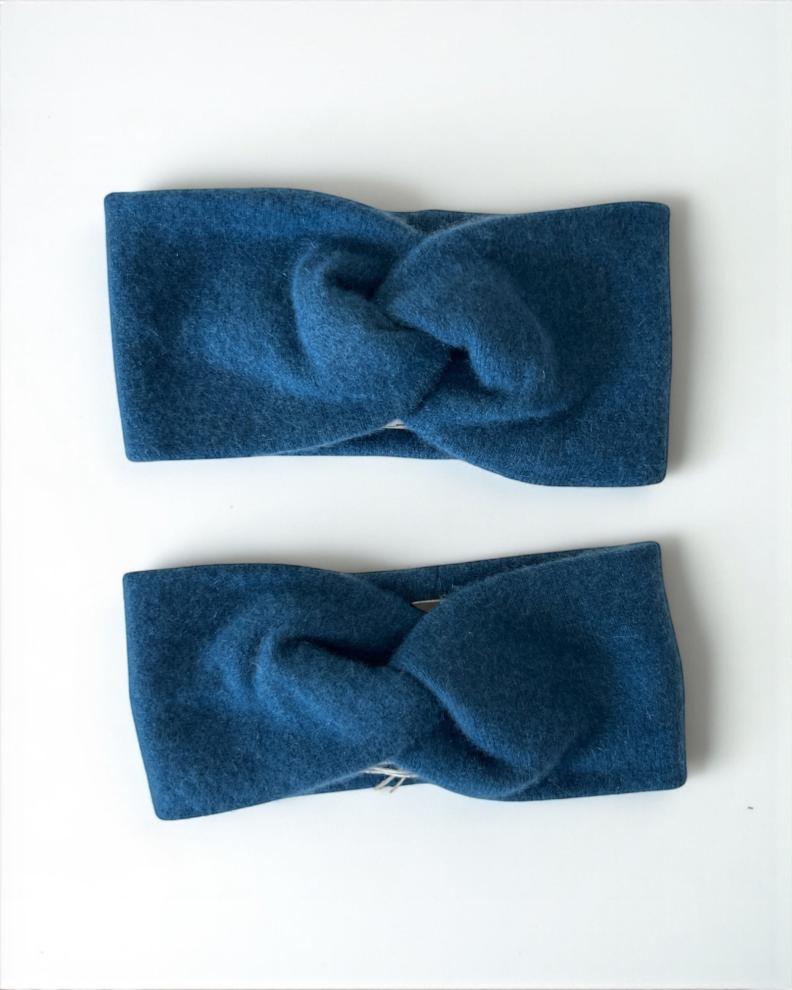 Two blue headbands with a knot design