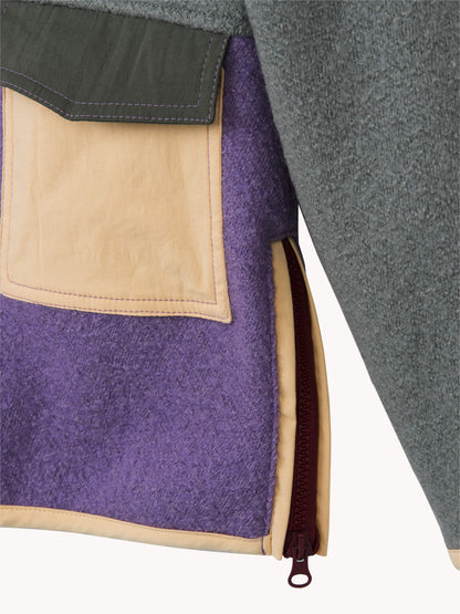Close-up of a jacket with purple, beige, and gray fabric