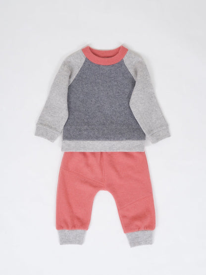 cashmere set of pants and sweater in color grey, coral on a white background