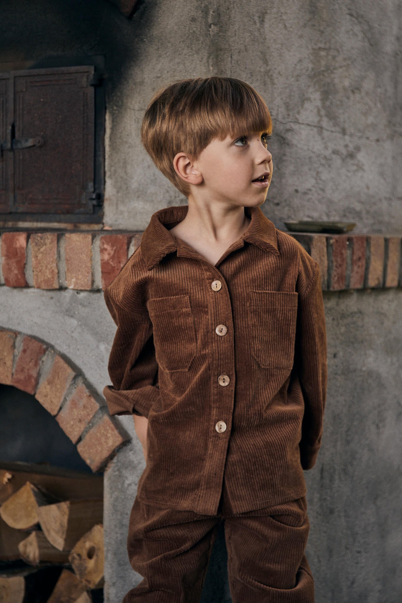 boy wearing brown corduroy set made of jacket and trousers