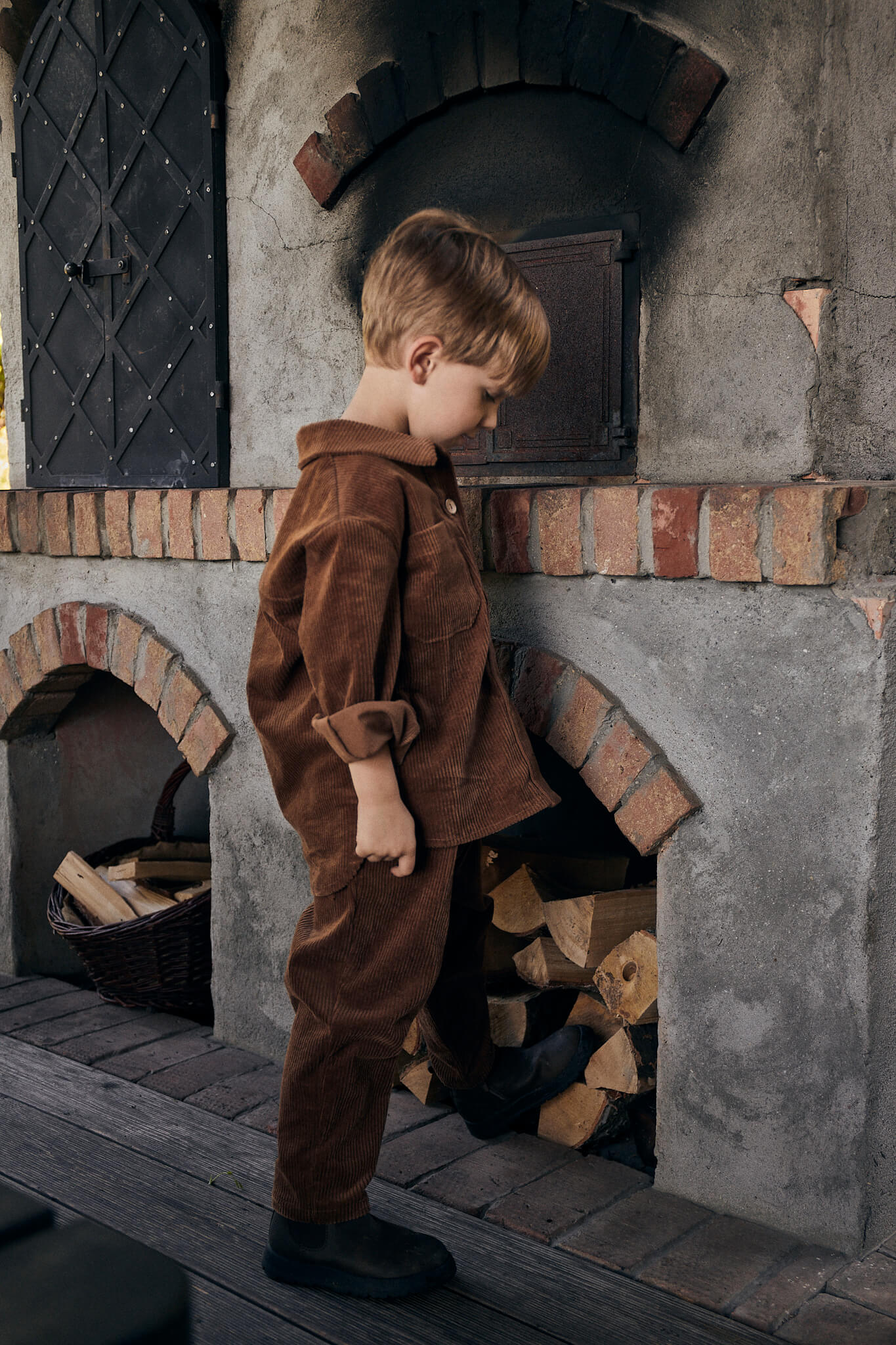 boy wearing brown corduroy set made of jacket and trousers