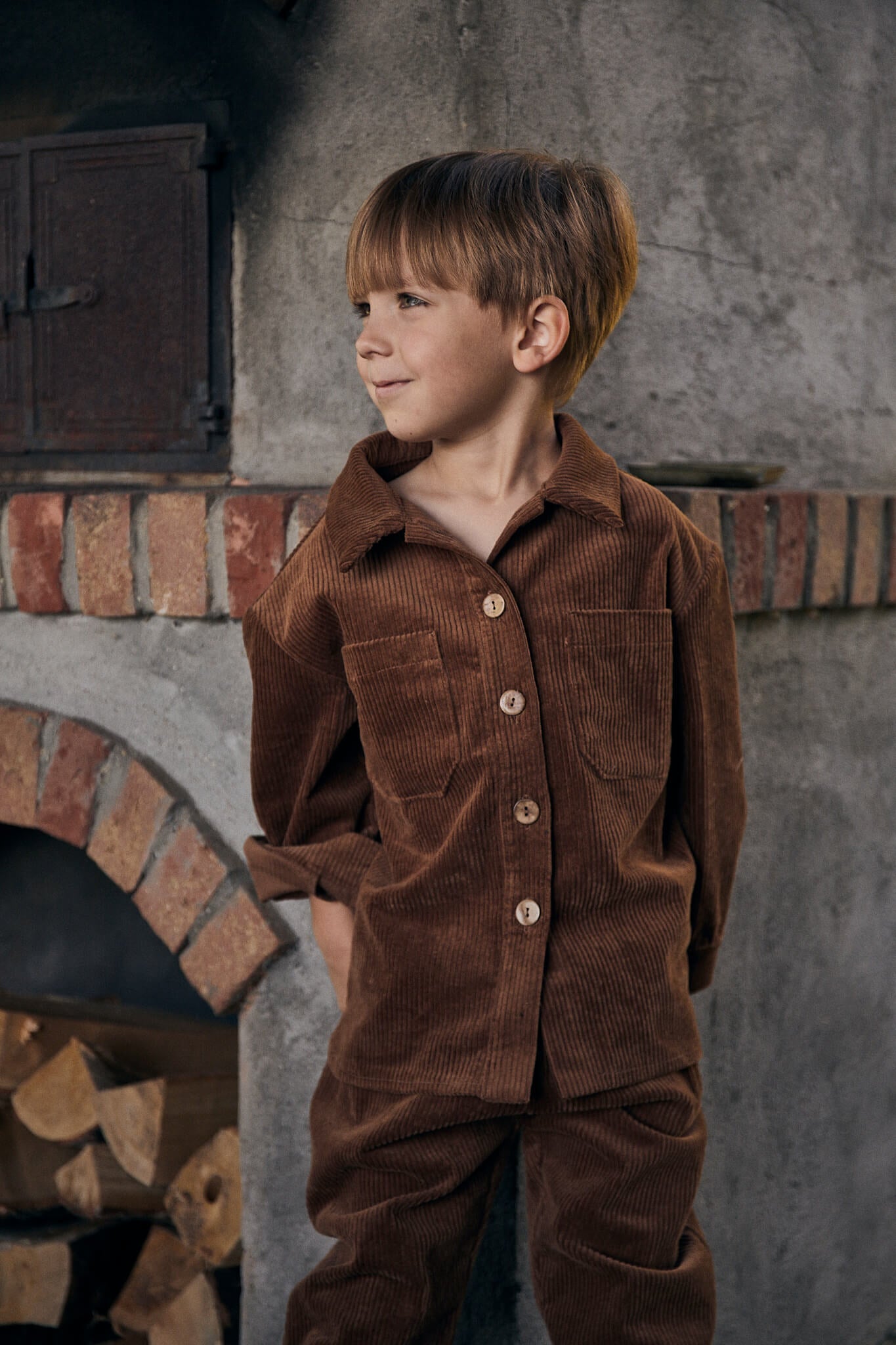 boy wearing brown jacket and trousers made out of corduroy