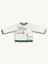 White longsleeve with a round neckline, loose fit, and a decorative contrasting ribbed cuff. It features a red and green print of a dachshund on the front.