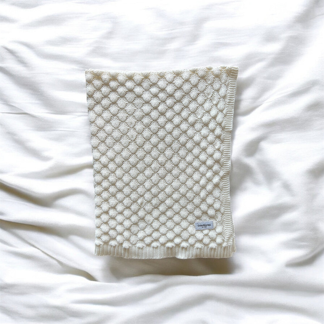 Textured blanket on a white fabric background