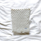 Textured blanket on a white fabric background