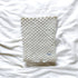 Textured blanket on a white fabric background