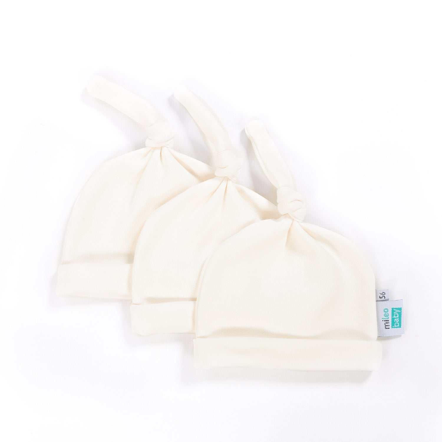 three organic cotton newborn hats on a white background