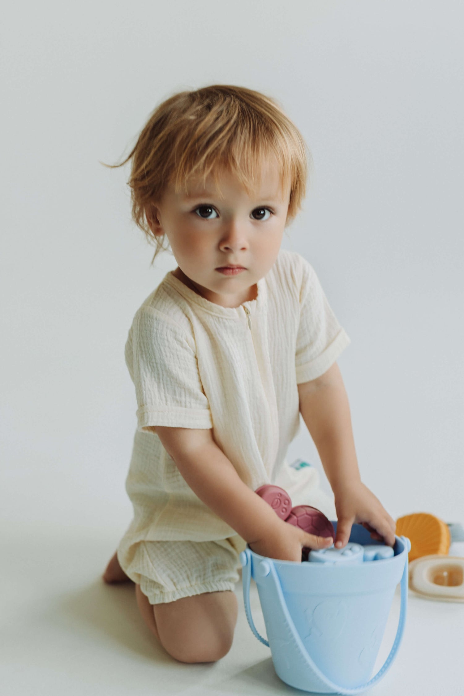 Child playing with toys on a white background