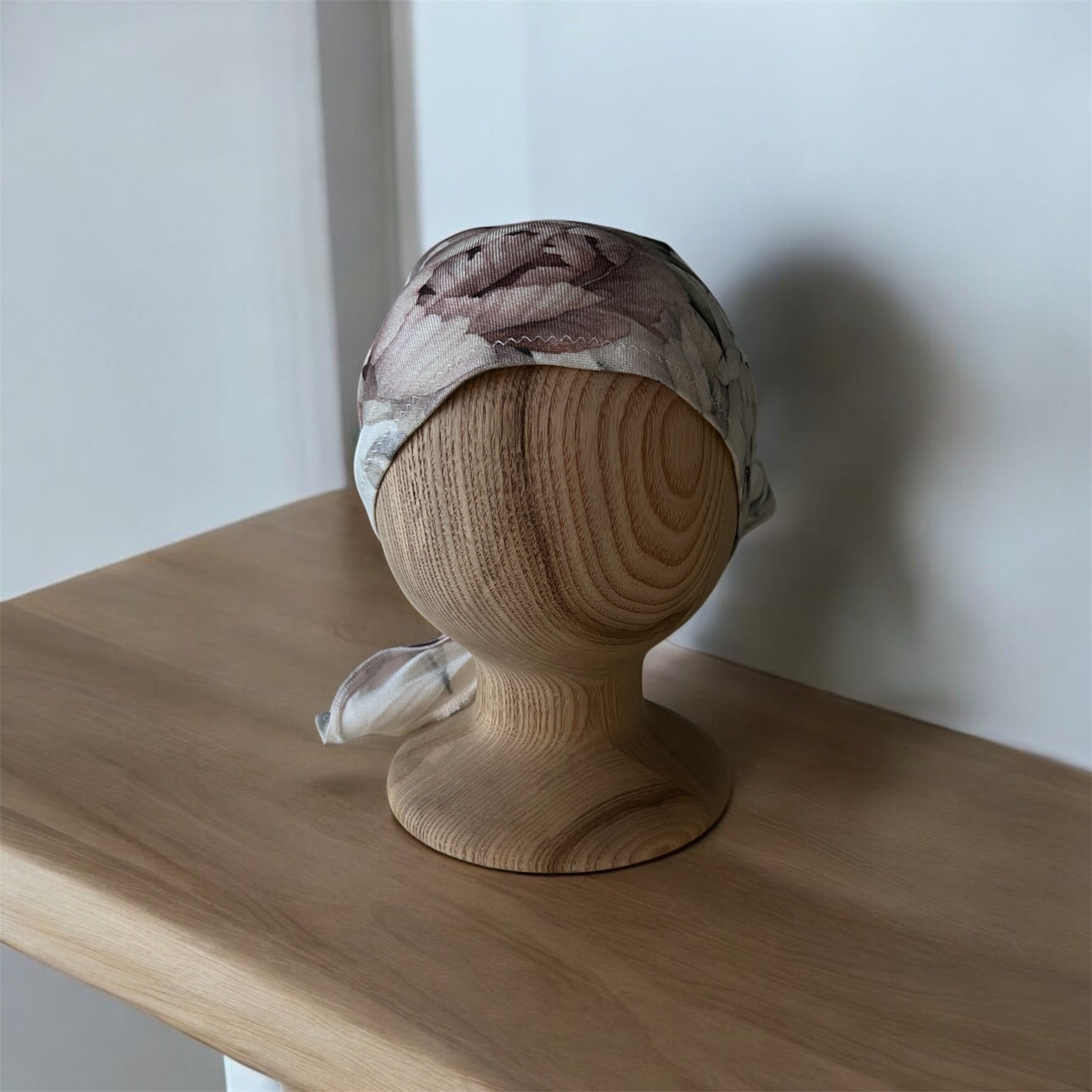 Floral headscarf on a wooden mannequin head