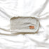 Baby blanket with flower pattern with a leather tag on a white background