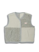 Two-tone vest with beige front and gray back on a black background